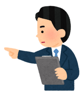 資料をもって指をさす会社員